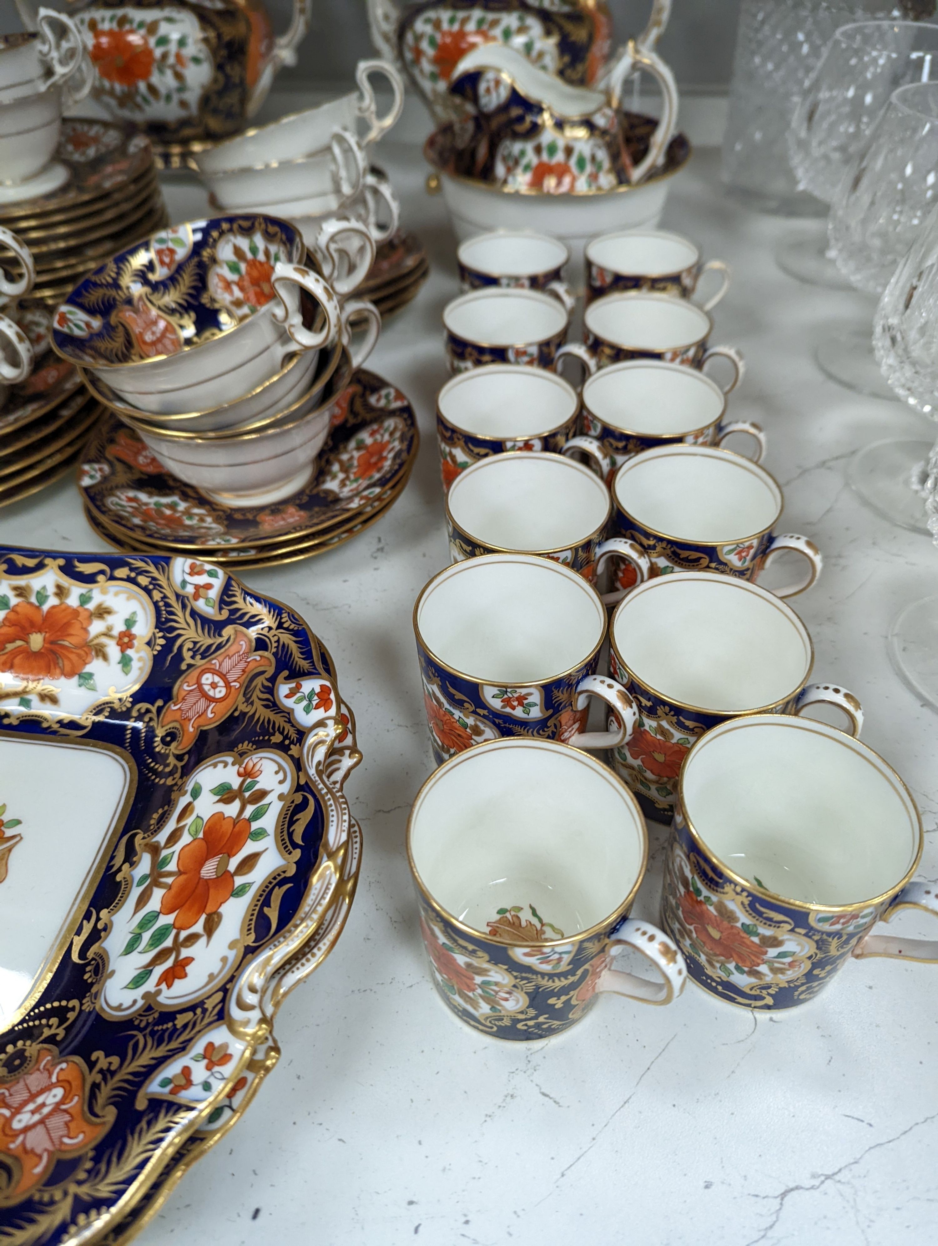 A mid 19th century English bone china fifty-two piece part tea and coffee service, decorated in an Imari pattern